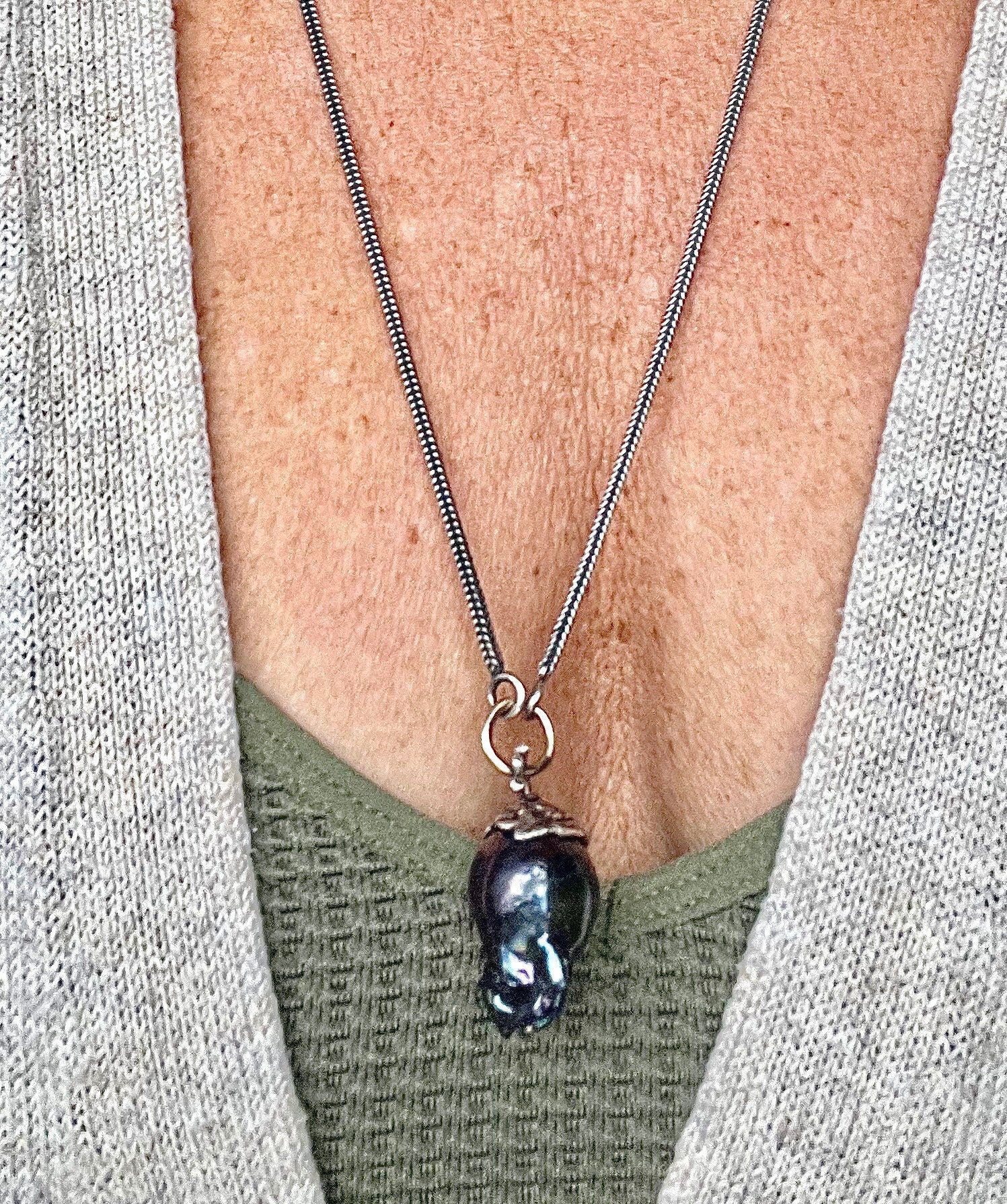 Large Black Baroque Freshwater Pearl on 22” S.Silver Snake Chain with 14K Gold Connector.